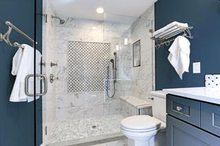 Castaway marble stream shower tray in a blue and whit bathroom