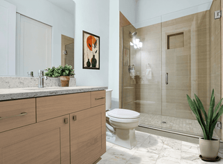 Soft stone warm tones shower tray in a brown and wood bathroom